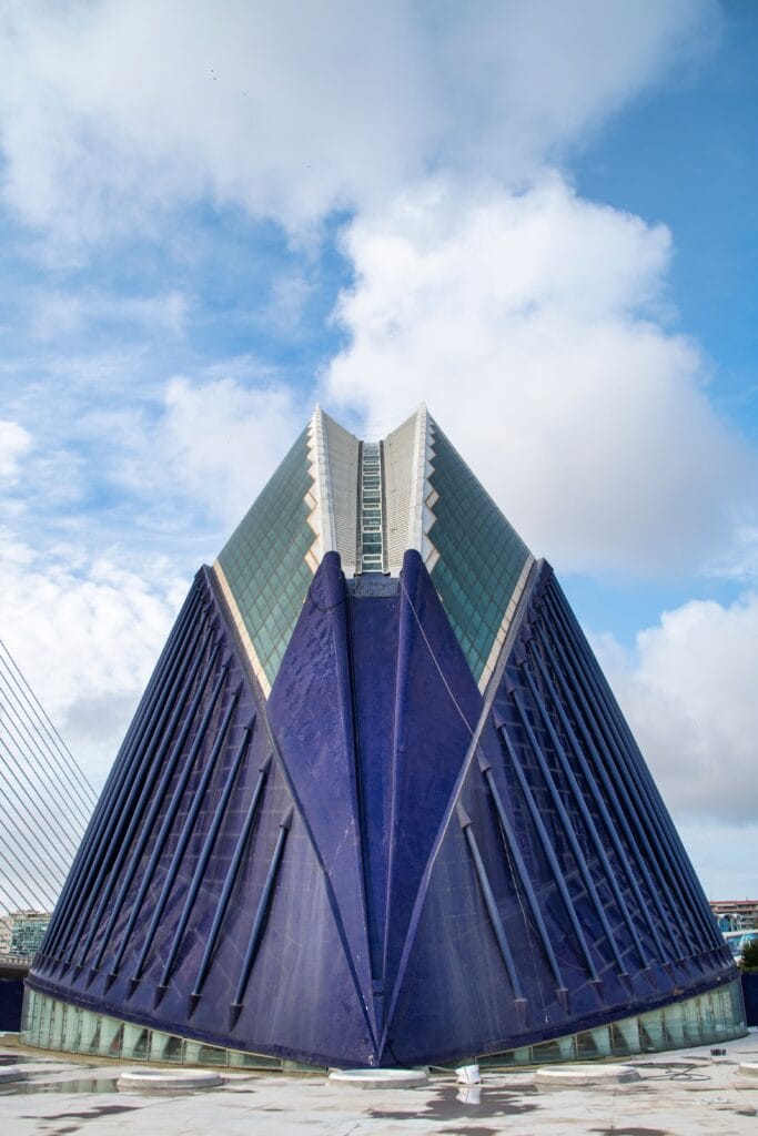 Captivating view of a modern, angular building with striking shapes and vibrant colors under a cloudy sky.