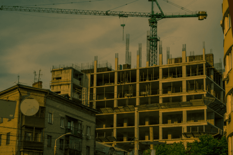 A crane over a modern building under construction in Dnipro, Ukraine.