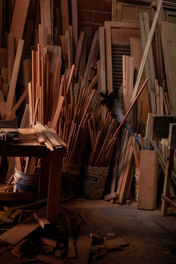 A collection of wooden planks and panels in an Argentine workshop during the day.