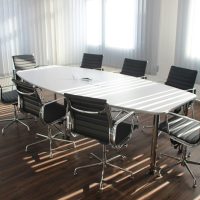 pexels-photo-416320-416320 Modern office meeting room with designer chairs, table, and large windows.